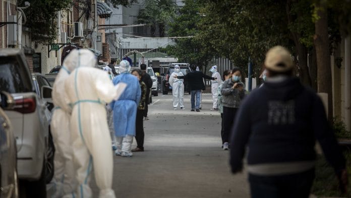 Workers in PPE facilitate a round of Covid-19 testing during a lockdown in Shanghai, China, on 7 April 2022 | Photo: Qilai Shen | Bloomberg