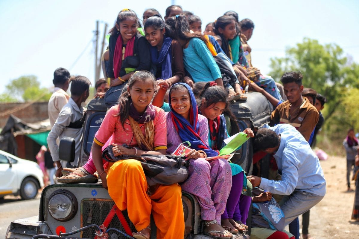 Students in Mahisagar sit on the bonnet of a public vehicle as they return home from school | Photo: Manisha Mondal | ThePrint
