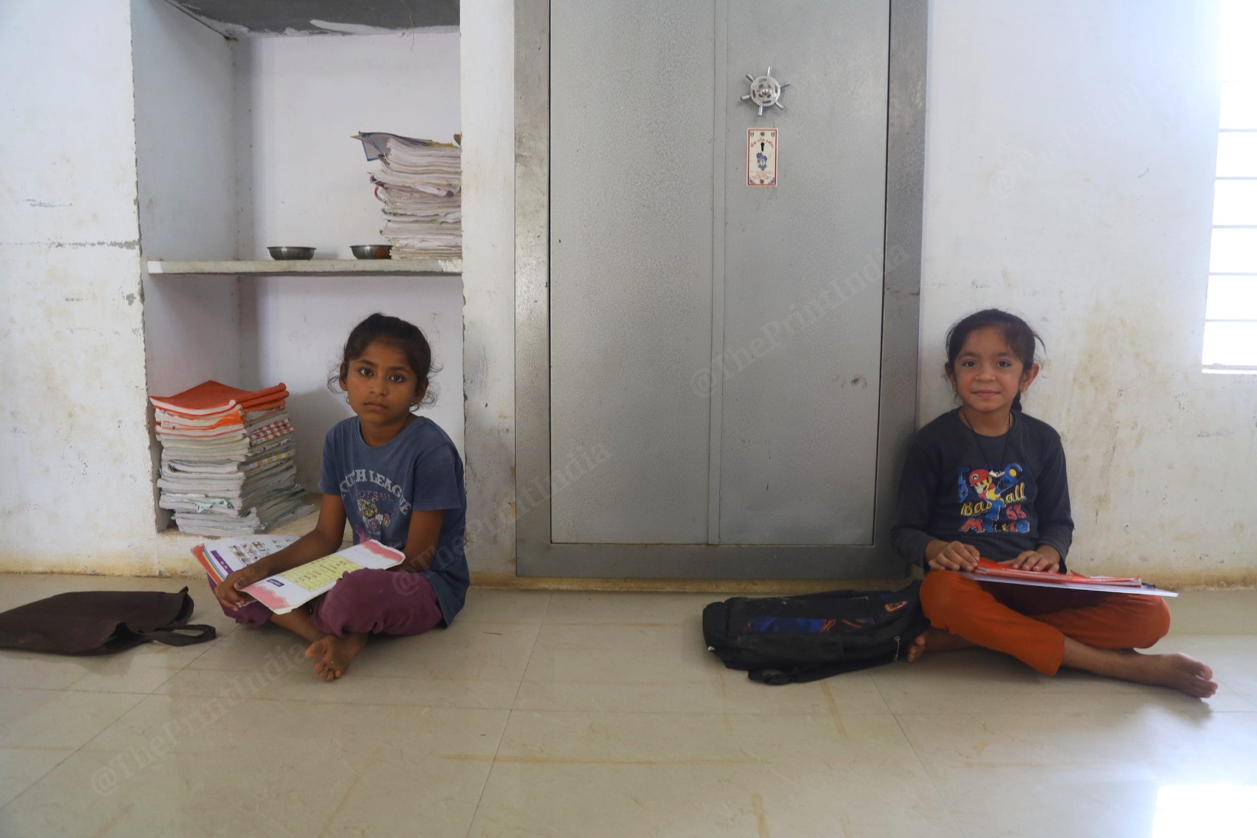 Class five students of Angiya Nana primary school sit with their books, as their teacher (not in the photo) teaches two classes simultaneously | Photo: Manisha Mondal | ThePrint