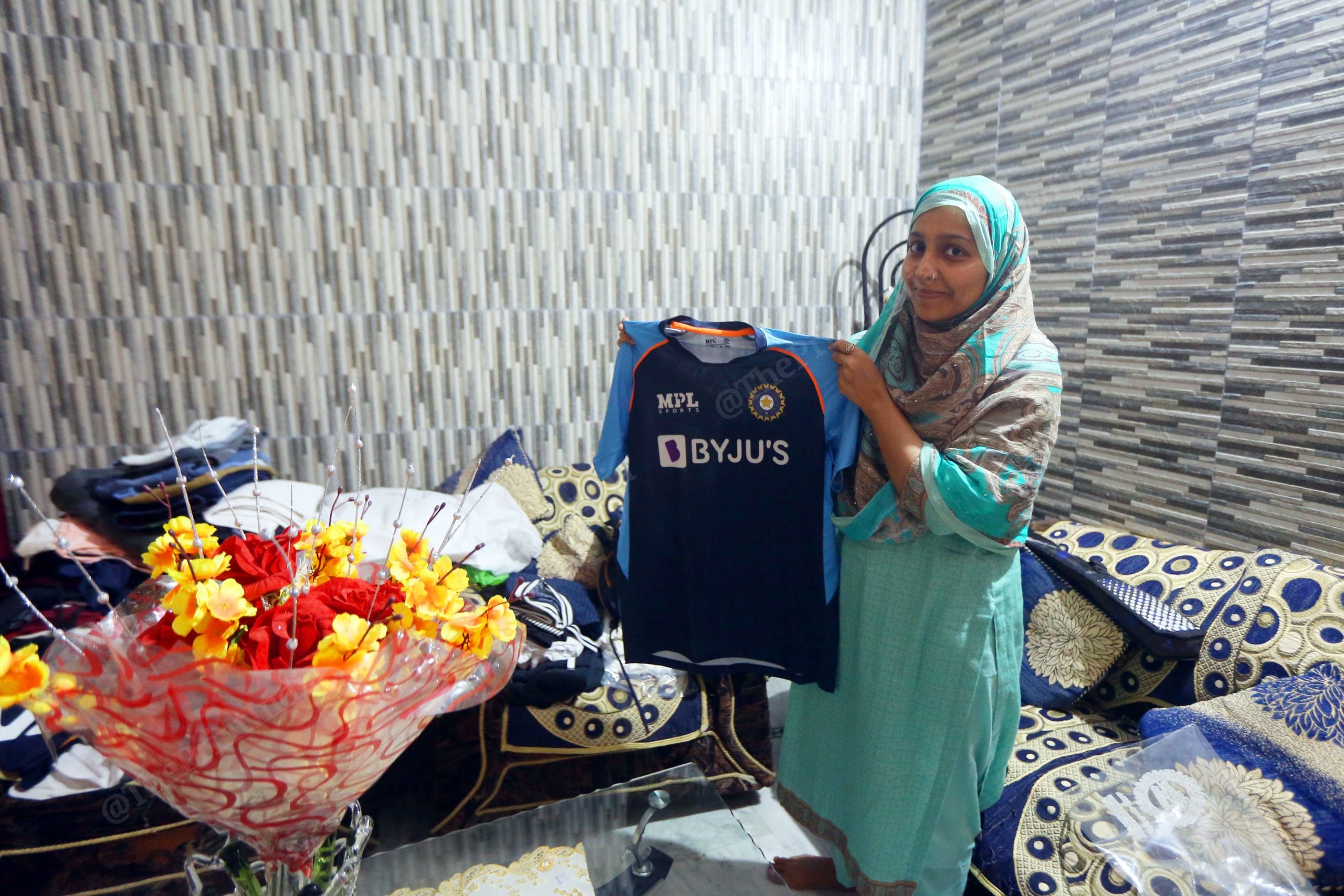 Shehnaz showing the Umran,s Malik Tshirt in his room | Photo: Praveen Jain | ThePrint