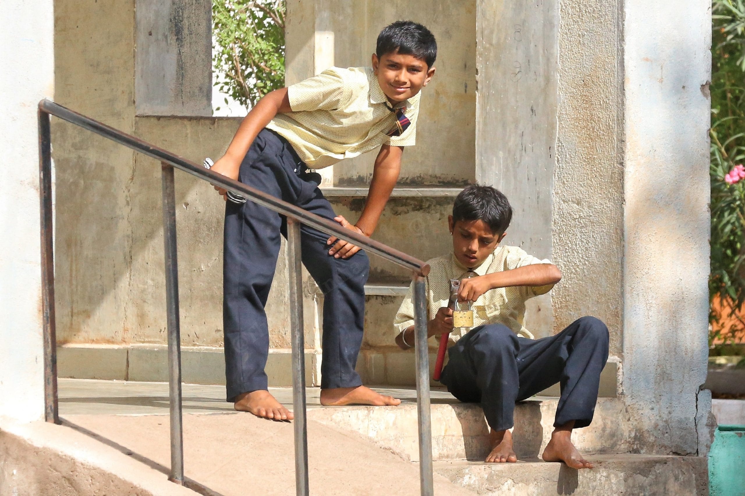 In Shree Shakti Nagar school in Kachchh, a student repairs a lock, as another stands by watching | Photo: Manisha Mondal | ThePrint