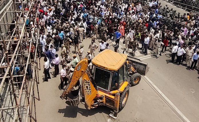 A bulldozer rolls in the Shaheen Bagh area during an anti-encroachment drive in New Delhi