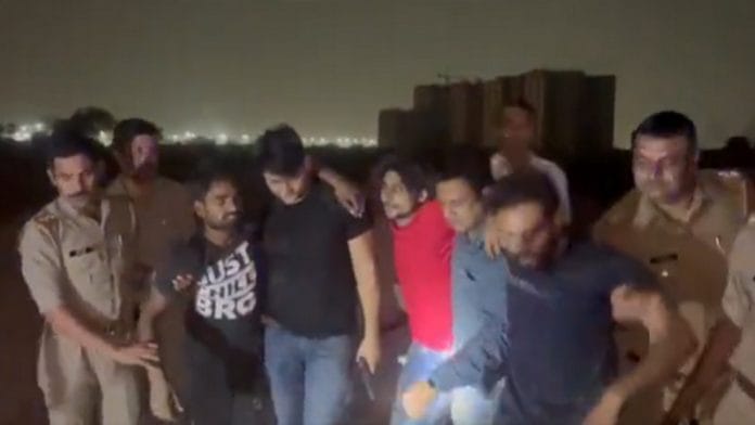 The alleged cow smugglers being led away by the police in Ghaziabad Wednesday | Screengrab