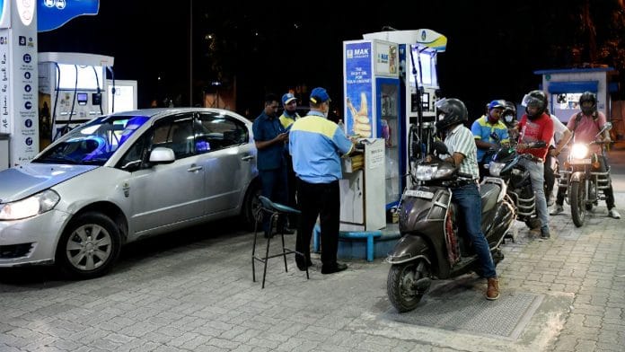 An attendant refills a two-wheeler with fuel at a petrol pump in New Delhi Saturday | ANI