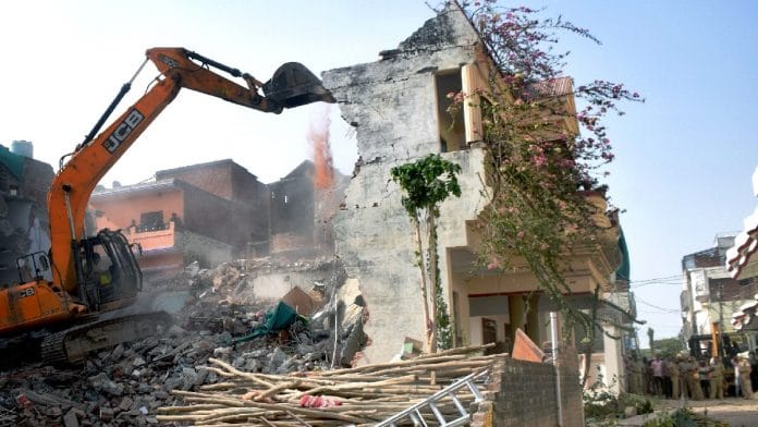 A bulldozer demolishing a house in Prayagraj on Sunday | ANI