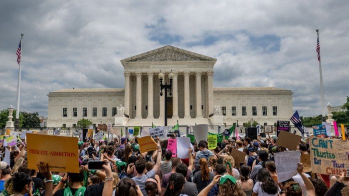 People protest in response to the Dobbs v Jackson Women's Health Organization ruling in front of the US Supreme Court, 24 June 2022 | Photo by Brandon Bell/Getty Images via Bloomberg