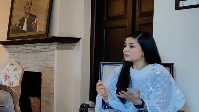 Iltija Mufti at her Srinagar home, with a portrait of her grandfather Mufti Mohammed Sayeed in the backdrop | Sajid Ali | ThePrint