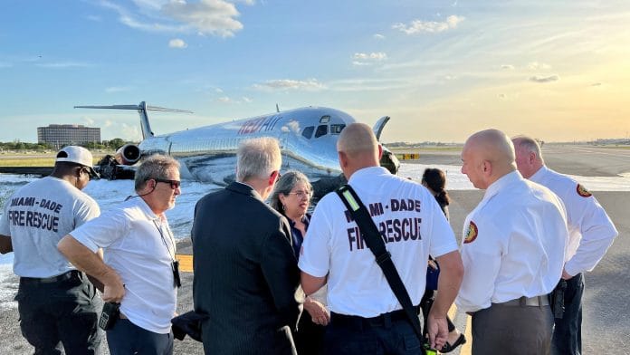 The plane which caught fire seen in the background at the on 22 June 2022