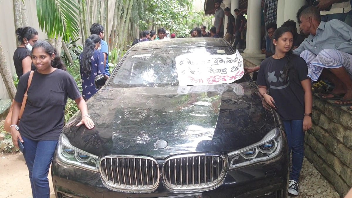  People pose with a luxury car inside the President's official residence in Colombo on 10 July | ThePrint | Regina Mihindukulasuriya