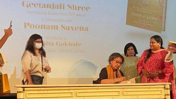 Geetanjali Shree signs copies of 'Tomb of Sand' at the India Habitat Centre, Delhi as fans wait in line