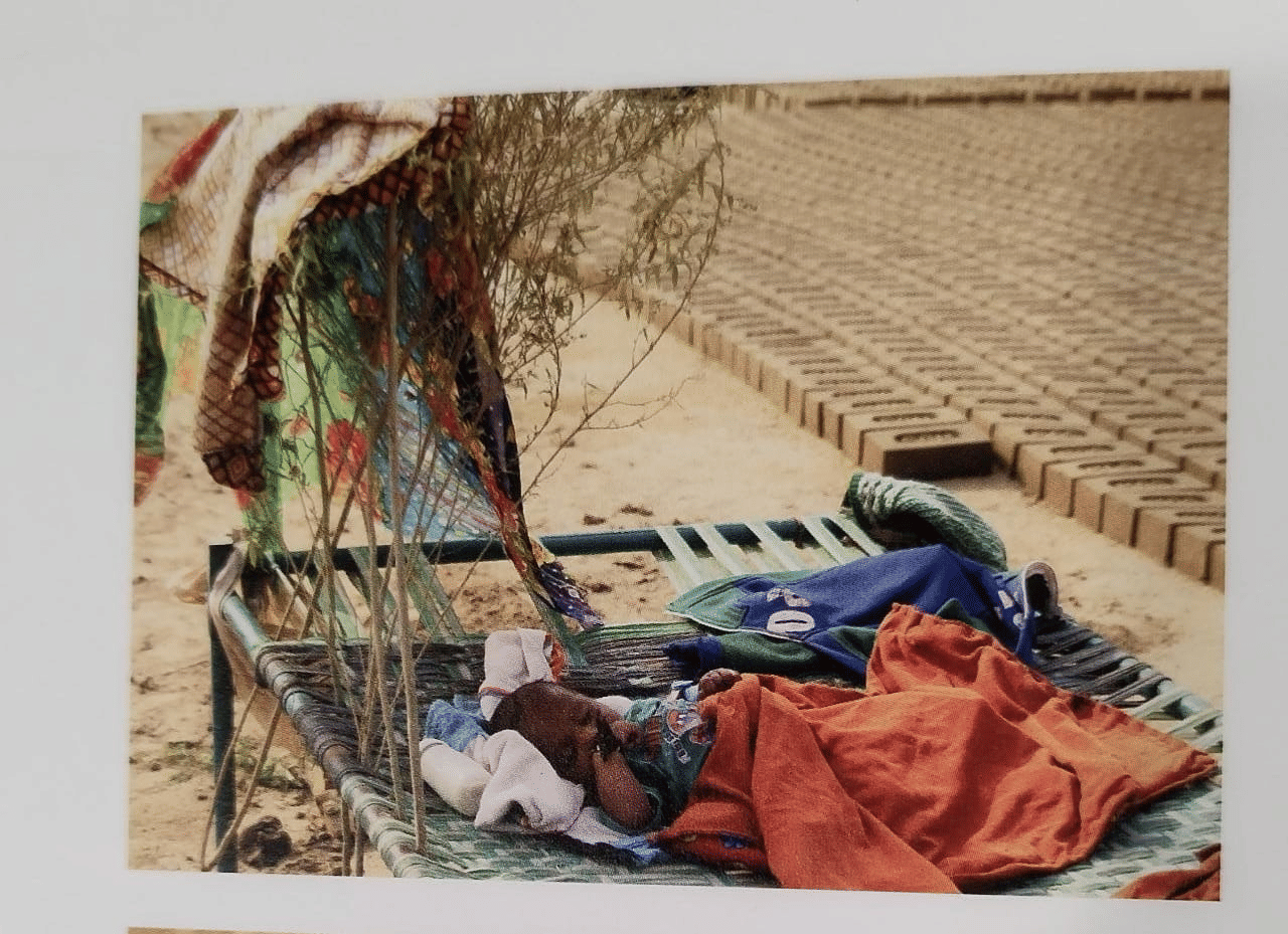 In a brick kiln with no trees in sight, parents made a canopy with branches to protect their baby from the harsh sun in Madhya Pradesh. | Photo Credit: Dishha Bagchi