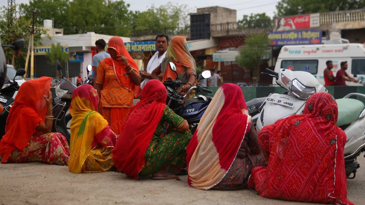 A group of women wait outside the police station for family members who have been detained | Photo: Manisha Mondal | ThePrint