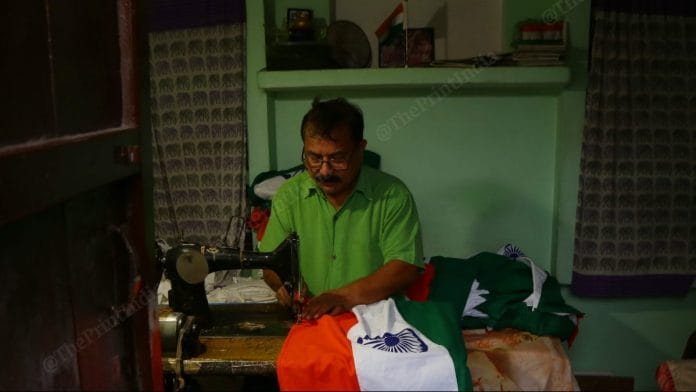 Ramesh Chandra stitches Khadi flags at his home in Meerut. | Photo Credit: Manisha Mondal