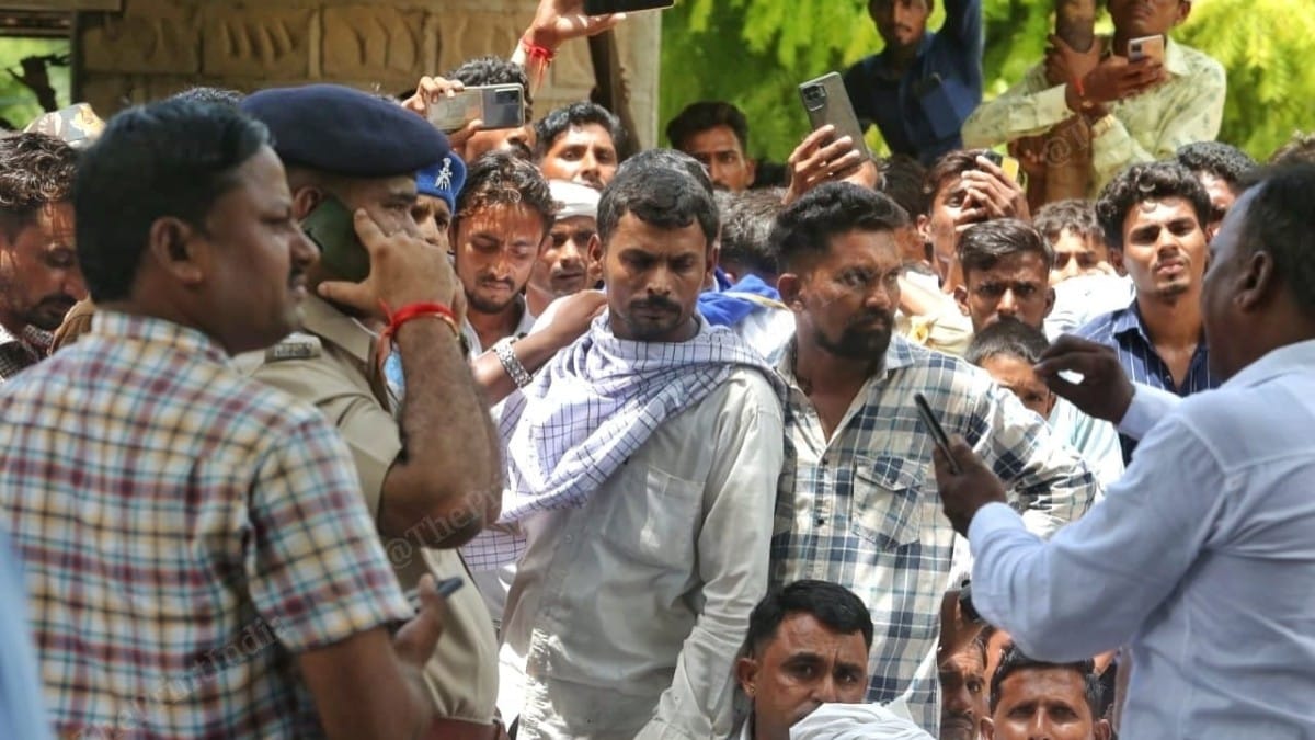 Inder's father Devaram Meghwal (wearing scarf) in conversation with police at his home in Surana village | Praveen Jain | ThePrint