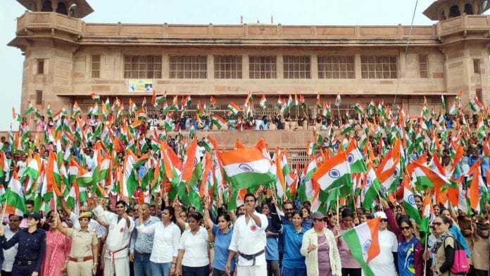 People hold national flags as they participate in the People hold national flags as they participate in the