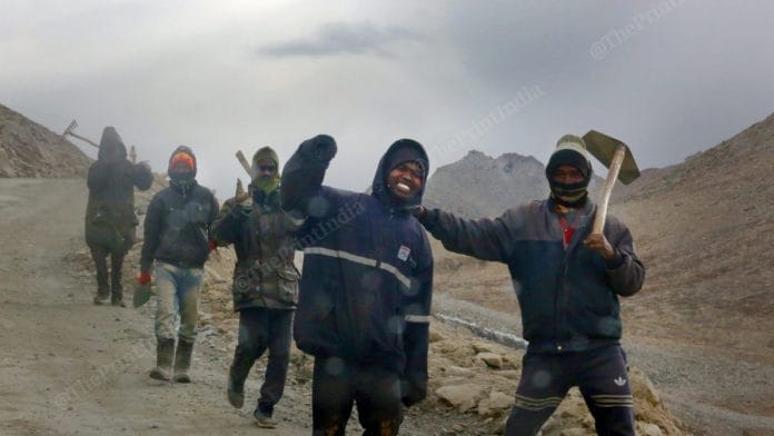 Construction workers walking along the Pangong Lake Road | Praveen Jain | ThePrint