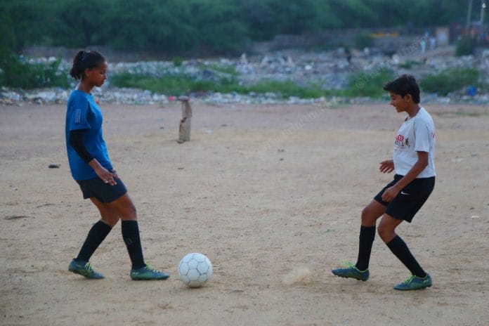 Julie and Sapna play on the ground which is 20 mins walking from their house. The girls cleaned the shrubs, grass, now one part of the ground has a park another is a dumping ground | Photo: Praveen Jain | ThePrint