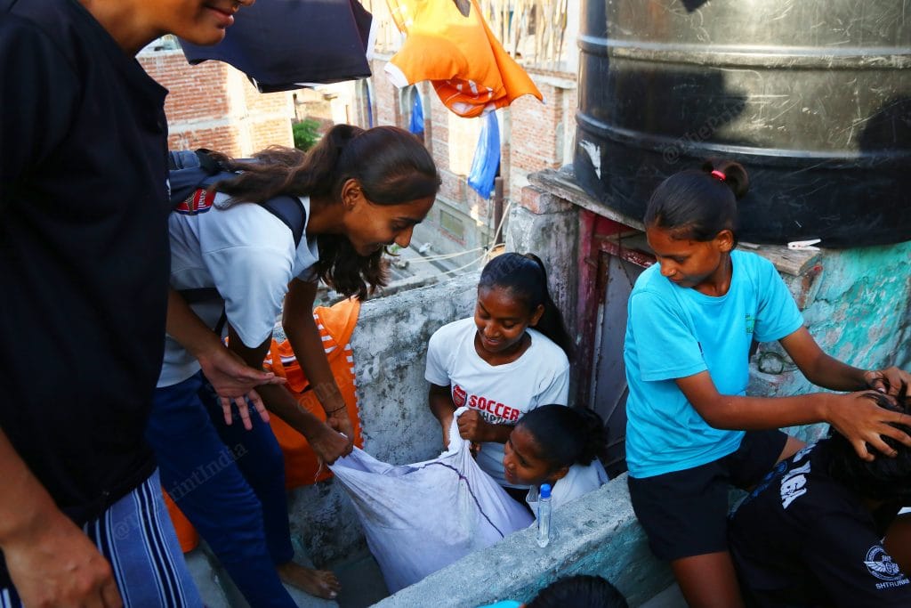 One group girls went to the vendor to get newly made jerseys. The girls coordinate among each other to get all the work sorted | Photo: Manisha Mondal | ThePrint