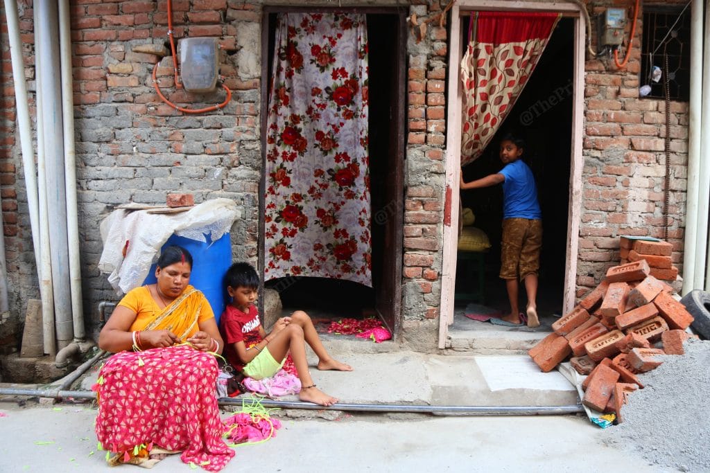 Caption: Beauty’s mother adds finishing touch to the dupattas, she has to supply them to the nearest factory | Photo: Manisha Mondal | ThePrint