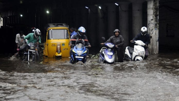 People wading through a flooded road following heavy rainfall in Chennai | ANI file photo