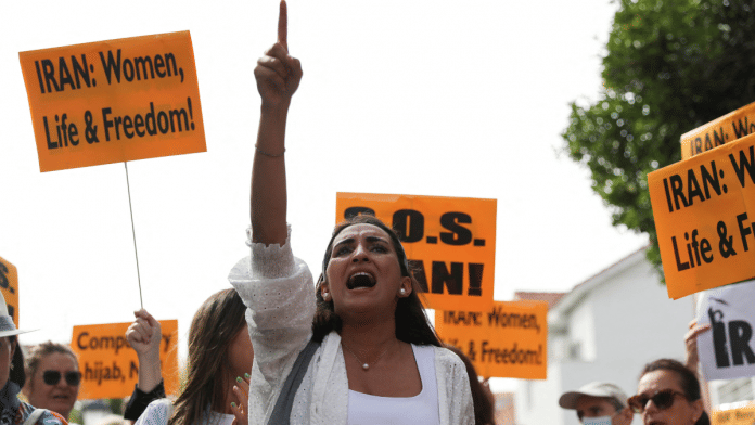 People take part in a protest in front of the Iranian Embassy in support of anti-regime protests in Iran following the death of Mahsa Amini, in Madrid, Spain September 28, 2022. REUTERS/Violeta Santos Moura