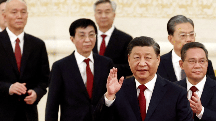 New Politburo Standing Committee members Xi Jinping, Li Qiang, Zhao Leji, Wang Huning, Cai Qi, Ding Xuexiang and Li Xi arrive to meet the media following the 20th National Congress of the Communist Party of China, at the Great Hall of the People in Beijing, China October 23, 2022. REUTERS/Tingshu Wang