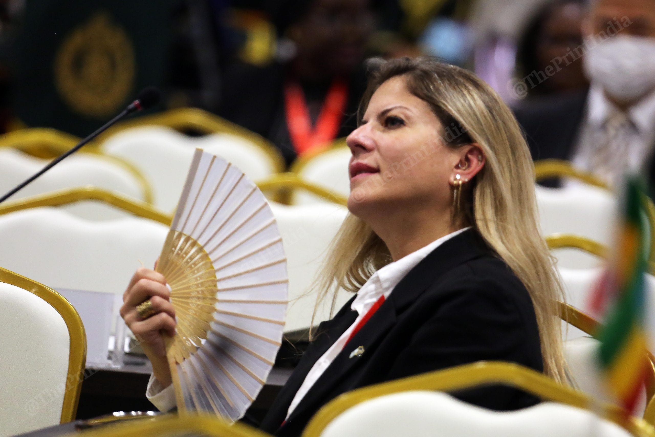 Delegate using a handmade fan during the 90th General Assembly of INTERPOL at Pragati Maidan | Photo: Praveen Jain | ThePrint