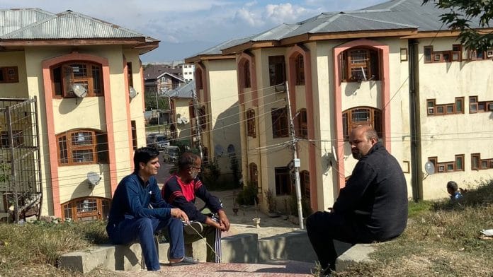 Some people sitting outside Sheikhpora Pandit Colony in Budgam | Ananya Bharadwaj | ThePrint