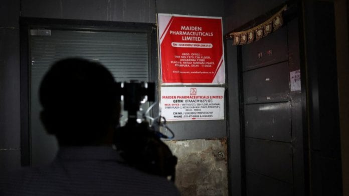 A cameraman takes visuals outside the office of Maiden Pharmaceuticals company in New Delhi, on 6 October 2022 | Anushree Fadnavis/Reuters
