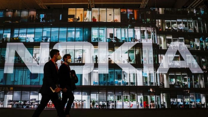 People walk past a Nokia stand during GSMA's 2022 Mobile World Congress in Barcelona, Spain | Reuters file photo