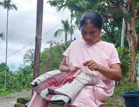 Victory Synrem, one of the three remaining women who know the Khneng craft, stitching embroidery pattern | Photo: NESFAS