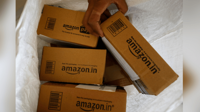A worker sorts delivery packages in a van outside an Amazon facility in Ahmedabad, India | Photo: Reuters/Amit Dave