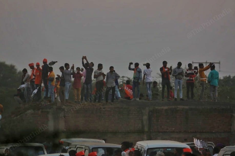 Locals in Kheda, climb on buildings to see PM Modi | Photo: Praveen Jain | ThePrint