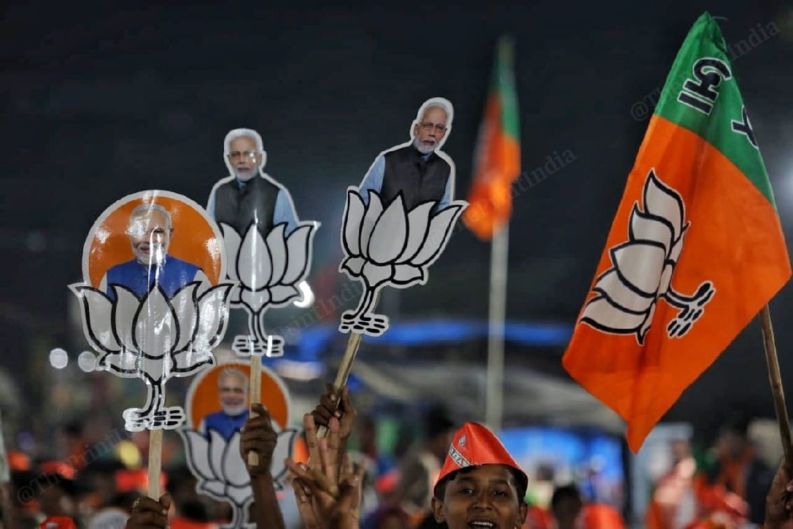 BJP supporters waving party flags, symbol at Amit Shah's rally in Ahmedabad | Photo: Praveen Jain | ThePrint