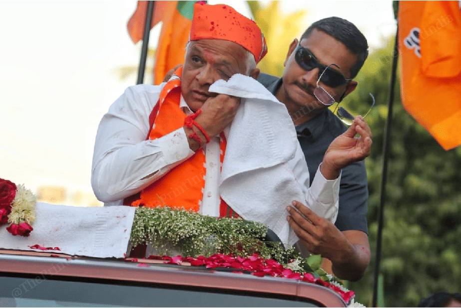CM Patel cleaning colour from his eyes during roadshow | Photo: Praveen Jain | ThePrint