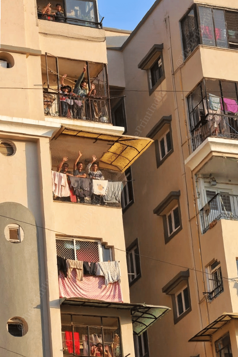Residents waving to Gujarat CM from their homes | Photo: Praveen Jain | ThePrint