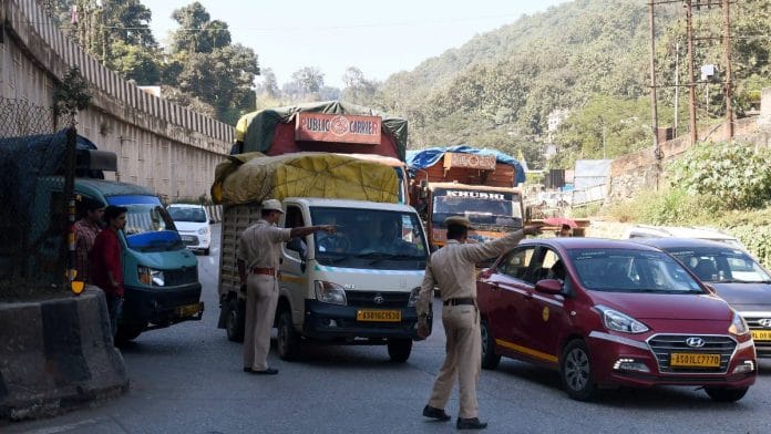 Police personnel stop Meghalaya-bound tourists at Jorabat near Guwahati on Wednesday | ANI
