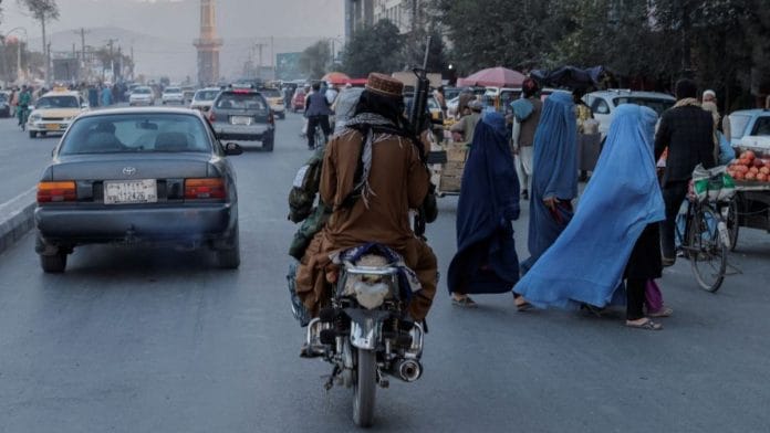 Respresentational image | A group of women wearing burqas crosses the street as members of the Taliban drive past in Kabul, Afghanistan | Reuters file photo/Jorge Silva