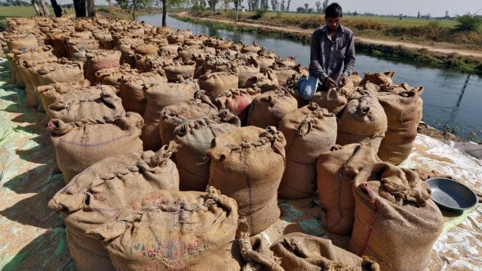 File photo of A worker packing a sack filled with rice on the outskirts of Ahmedabad 27 February, 2015 | Reuters