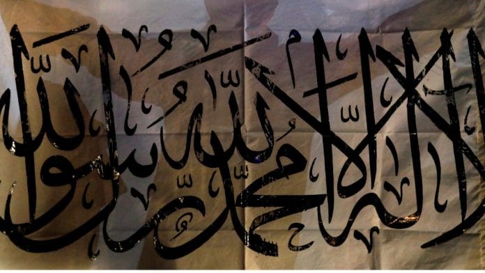 File photo of a Taliban supporter holding an Islamic Emirate of Afghanistan flag on the first anniversary of the departure of US forces from Afghanistan, on a street in Kabul, Afghanistan, 30 August, 2022 | Reuters