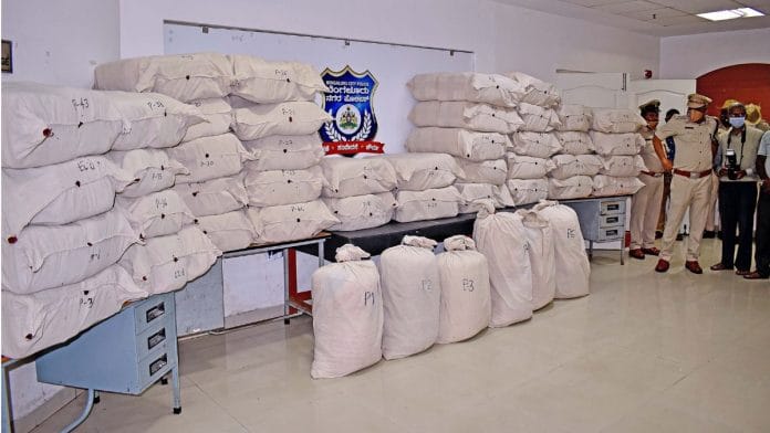 File photo of police personnel standing as 1,350 kg of marijuana (Ganja) seized by Seshadripuram police, in Bengaluru on 10 September, 2022 | ANI