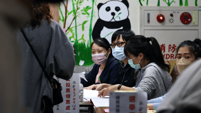 People line up to cast their votes on election day in Taipei, Taiwan | Photo: Reuters/Ann Wang