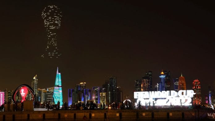 A drone show with the World Cup trophy on display is seen above the skyline of Doha, Qatar, on 15 November 2022 | Reuters