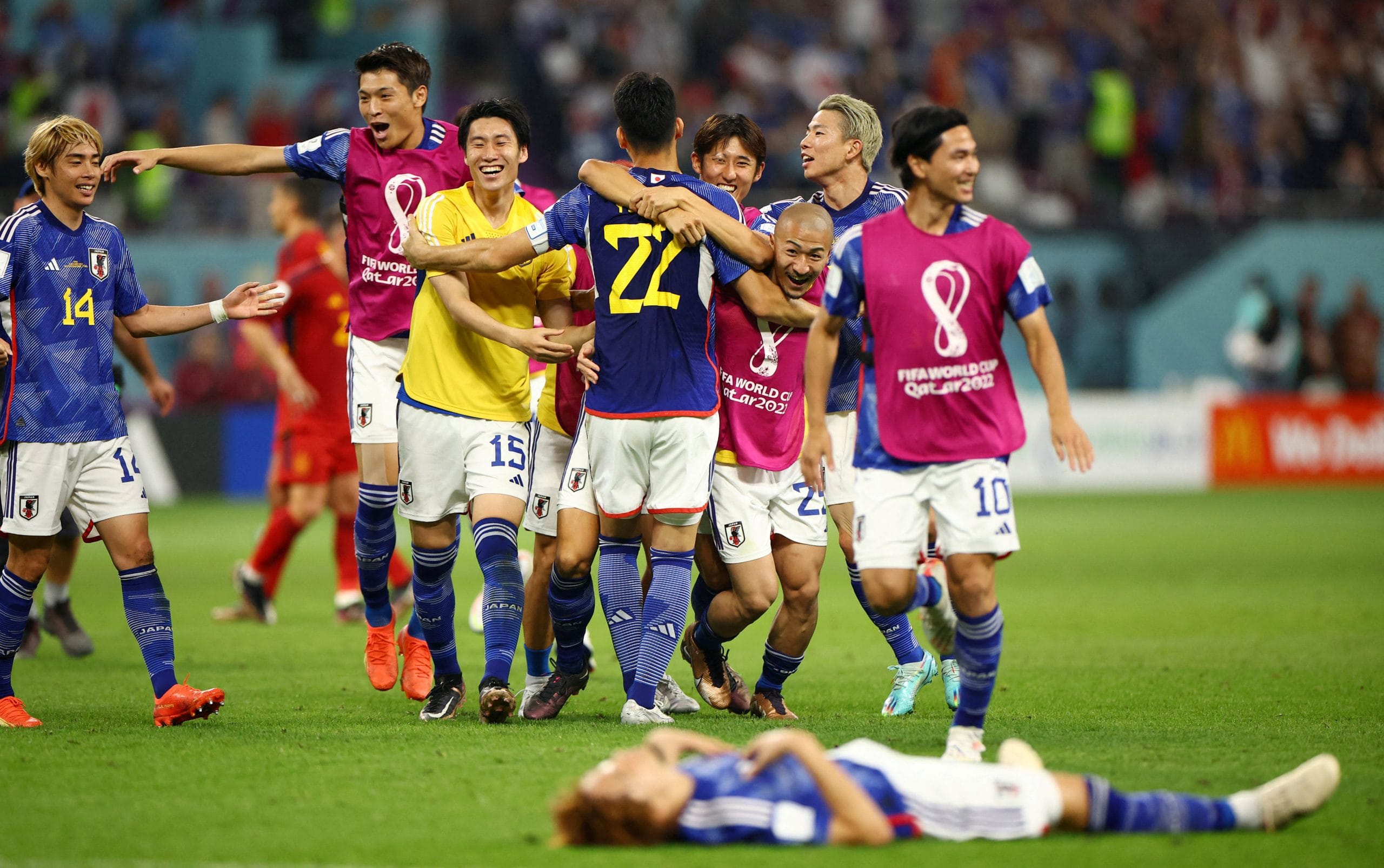 Japan's Maya Yoshida and Daizen Maeda celebrate with teammates after the match against Spain at Khalifa International Stadium, in Doha, on 2 December 2022 