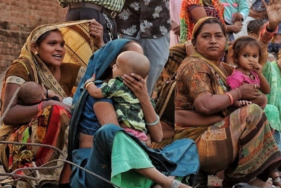 Women sitting on the side of the road, waiting for PM Modi's cavalcade | Photo: Praveen Jain | ThePrint