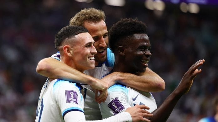 England's Bukayo Saka celebrates scoring their third goal with Harry Kane and Phil Foden against Senegal at Al Bayt Stadium, Al Khor, on 4 December 2022