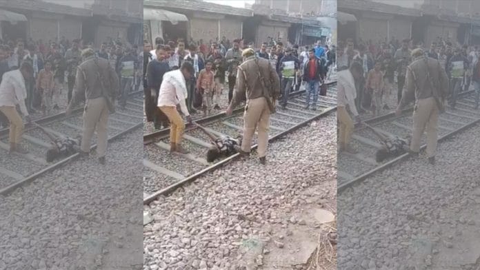 Screengrab from an eyewitness video of the incident shows Arsalan’s brother and a police officer moving him off the tracks | By special arrangement