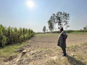The field where Vikrant hanged himself, one of his uncles standing at one corner. The family got rid of all the rose wood trees, as it would remind them of the horrible visual of their son hanging | Jyoti Yadav, ThePrint
