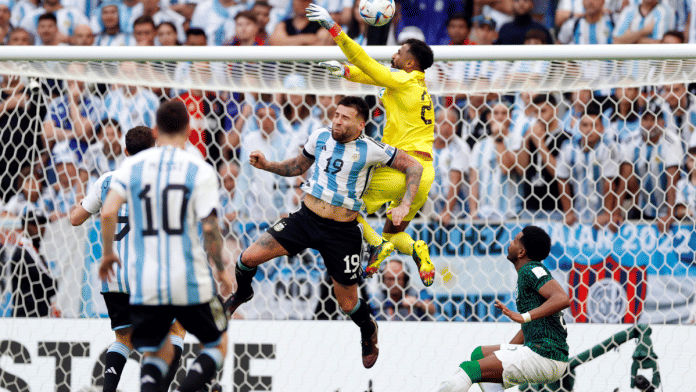 Saudi Arabia midfielder Salem Al-Dawsari is congratulated by teammates after scoring a goal against Argentina during a group stage match during the World Cup at Lusail Stadium | Yukihito Taguchi/USA Today via Reuters