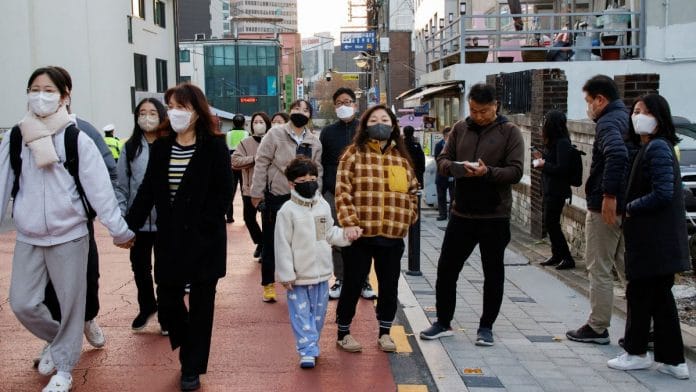 File photo of students and their family members ahead of the annual college entrance examinations in Seoul, South Korea on 17 November, 2022 | Reuters